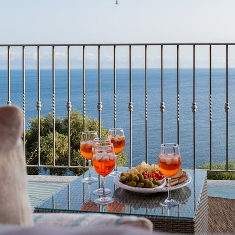 Enjoy Aperol Spritzes on the sea-facing terrace