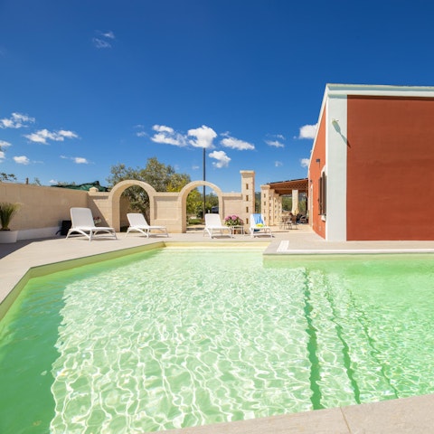 Soak up the sun by the shared swimming pool