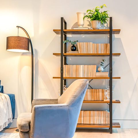 Grab a book from the host's collection and snuggle up on the blue velvet sofa for a reading session