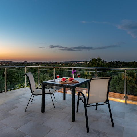 Head up to the roof terrace with a glass of wine and watch the sunset over the bay