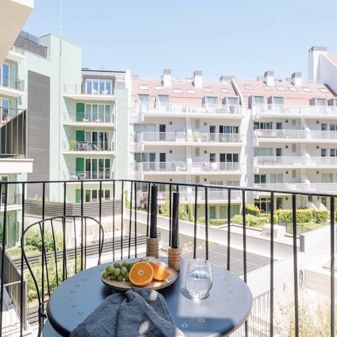 Sit out on the private balcony with a cold glass of ginjinha