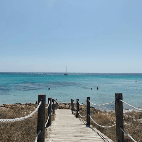 Head down to Playa de Talamanca for a day of Balearic sunshine, a short drive away