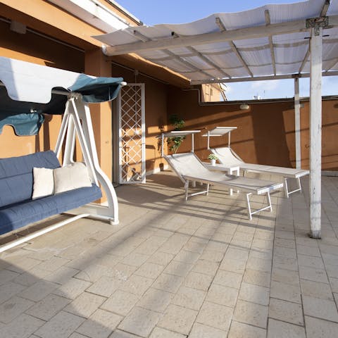 Enjoy an evening aperitivo on your private terrace with views of St. Peter's Basilica