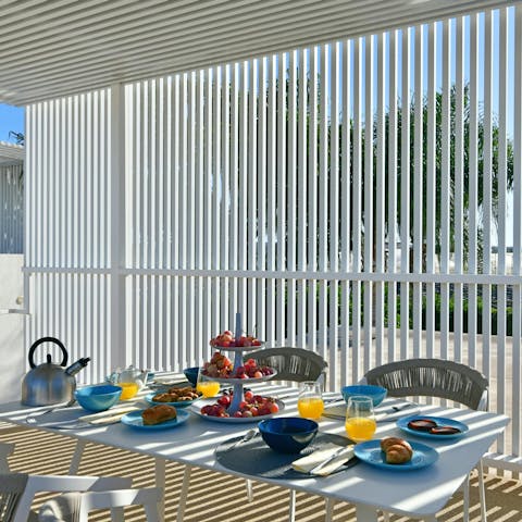 Enjoy breakfast under the shaded terrace