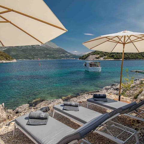 Listen to the water gently lap the shore as you doze off on a lounger