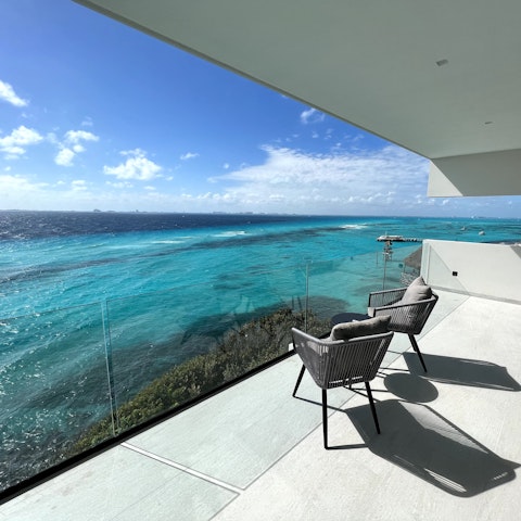 Sit out on the private balcony with a drink as the sun sets over the sea