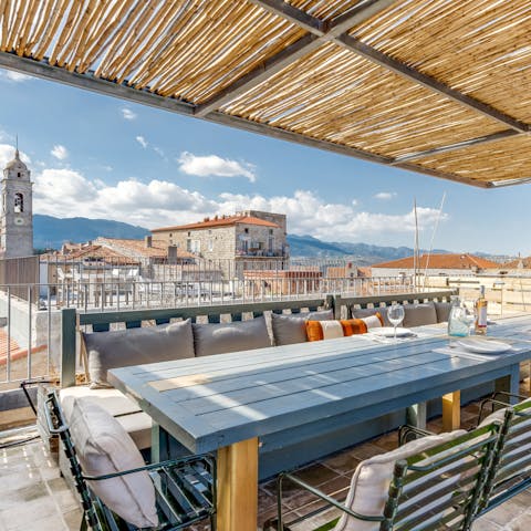 Dine alfresco on the shaded roof terrace with views out over the town