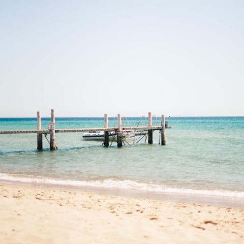 Spend a day on the sand at Capo Bianco Beach, a fifteen-minute drive away