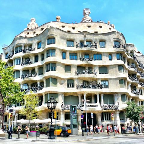 Take a self-guided tour of Casa Milà, a ten-minute walk away