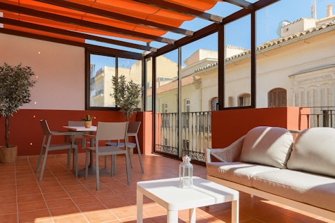Dine or unwind above Málaga's historic rooftops in the sun