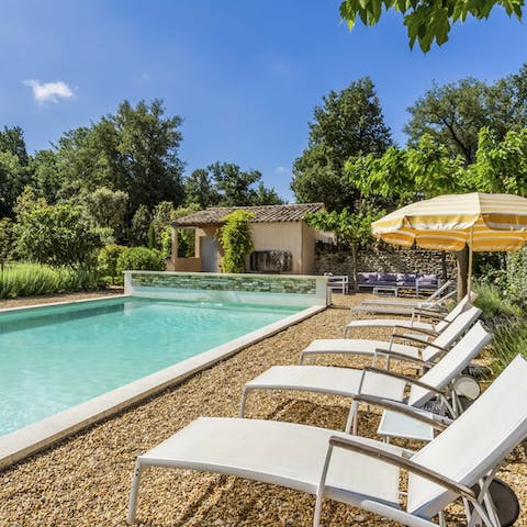 Relax and unwind by the pool, a glass of French wine in hand