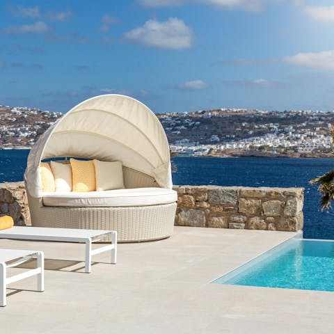 Laze on sun loungers before cooling off with a dip in your private infinity pool