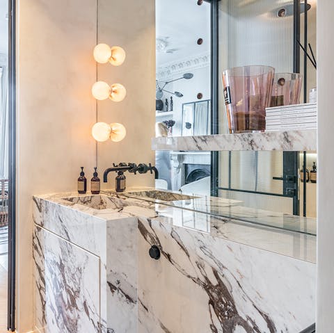 Get ready for an evening out in London in the stylish marble-clad bathroom