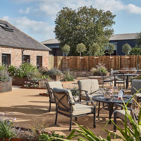 Grab a bottle of wine and get snug at the outdoor seating area, complete with fire pit