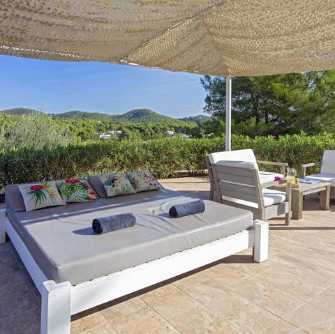 Sprawl out on the day bed and admire the views of the Ibizan countryside
