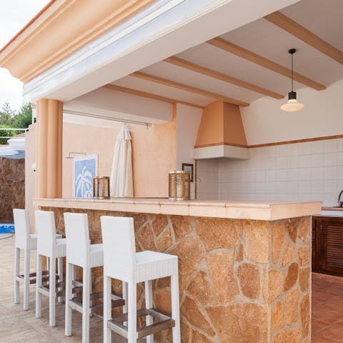 Cook up something magical in the outdoor kitchen or take up residence at the bar instead