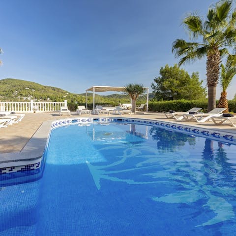 Jump into the large swimming pool and cool off underneath the fountain