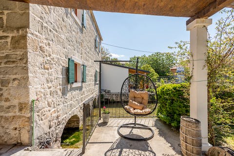 Settle down in the hanging egg chair with a good book and a glass of wine