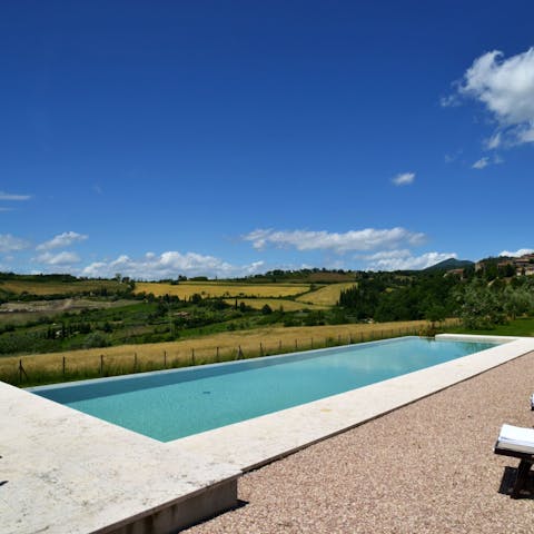 Take in the views of the Tuscan countryside from the shared pool