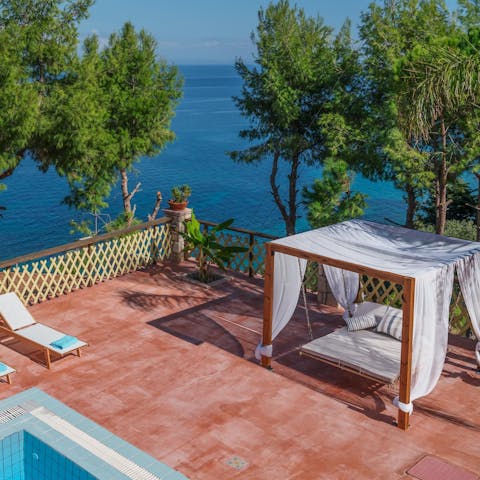Spend the afternoon swaying on the suspended day bed