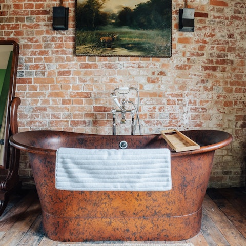 Soak your cares away in the deep, roll-top copper bathtub