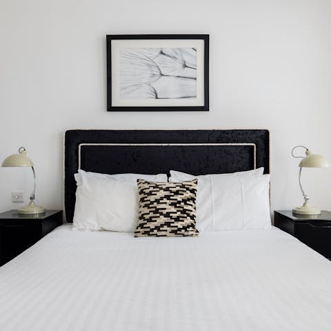 Fall asleep to the city's twinkling lights in the chic monochrome bedrooms