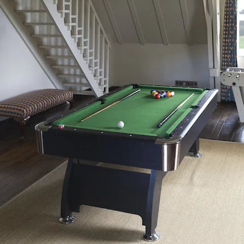 Get competitive over a round of billiards in the games room