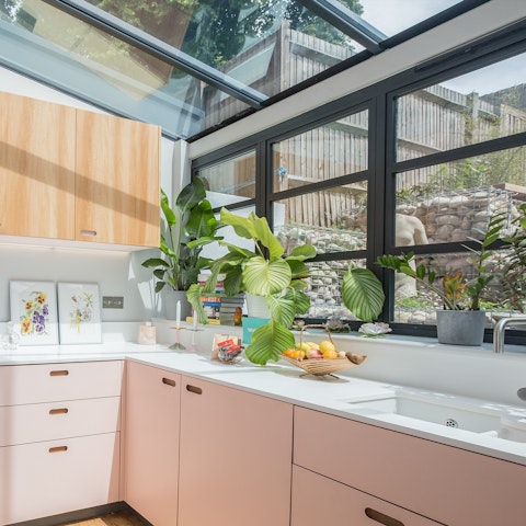 Savour your morning coffee in this striking, conservatory-like kitchen