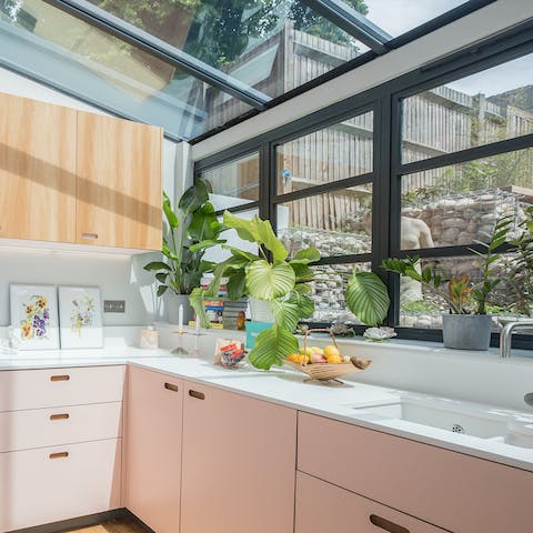Savour your morning coffee in this striking, conservatory-like kitchen