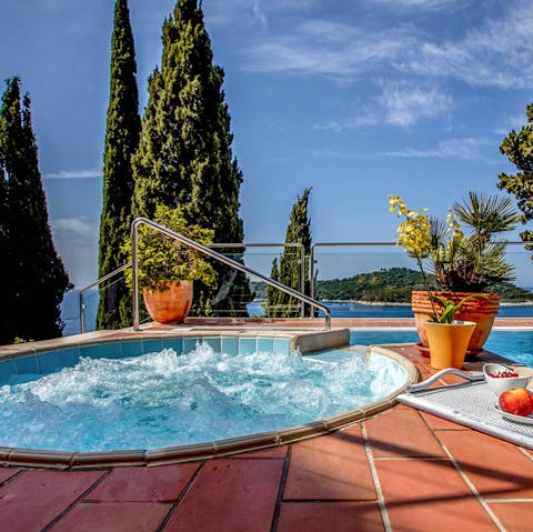 Unwind with a soak in the Jacuzzi and catch a glimpse of the sea