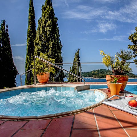 Unwind with a soak in the Jacuzzi and catch a glimpse of the sea