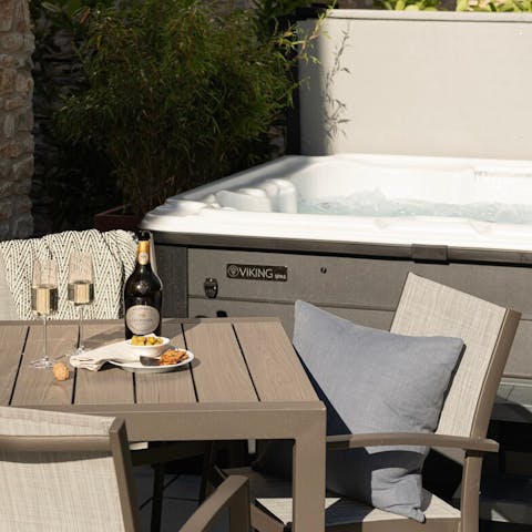 Unwind in the hot tub with a glass of fizz