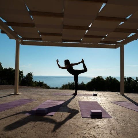 Find peace while perfoming sun salutations at the shared yoga pagoda