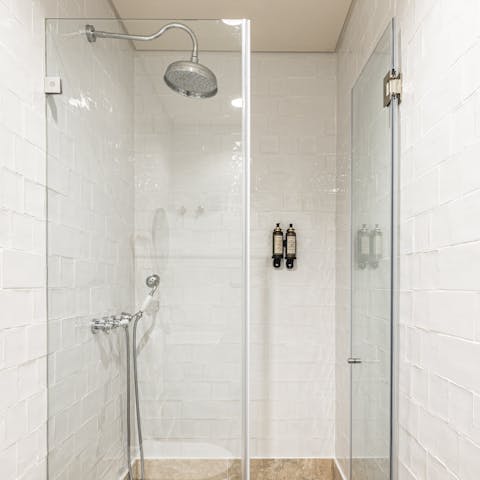 Relax and unwind beneath the rainfall shower after a day of sightseeing
