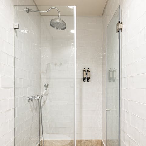 Relax and unwind beneath the rainfall shower after a day of sightseeing