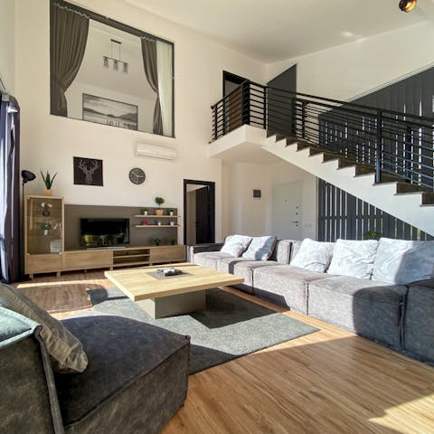 Relax indoors or get some remote work done as sunlight bathes the home through large windows