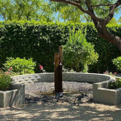 Sit on the wall and listen to the soothing sounds of the water feature