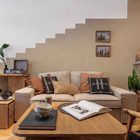 Kick back in the stylish living room with a glass of wine after a day of exploring the city