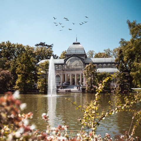 Take an afternoon stroll through El Retiro Park, a five-minute walk away