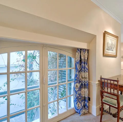 Look out to trailing ivy and lush foliage from the dining area