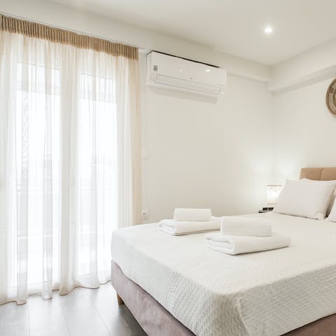 Wake up after a restful sleep and open your curtains to let the sunlight pour in, illuminating the white surfaces