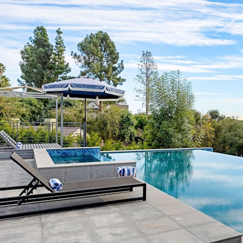 Relax by the pool overlooking the rolling countryside