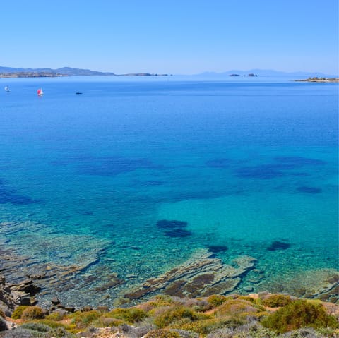 Walk for twenty-eight minutes or drive for six-minutes and you'll come across Paralia Agia Irini - a peaceful beach tucked in by palm trees