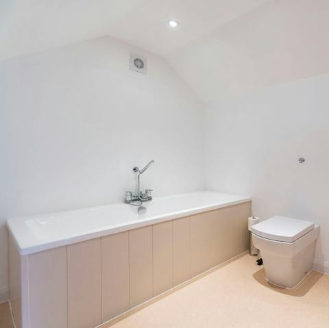 Sink into a hot bath after a day exploring the coastline