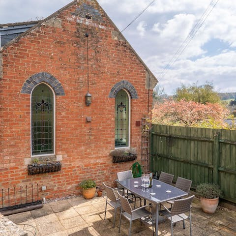 Dine alfresco beside the stained glass windows of a former chapel