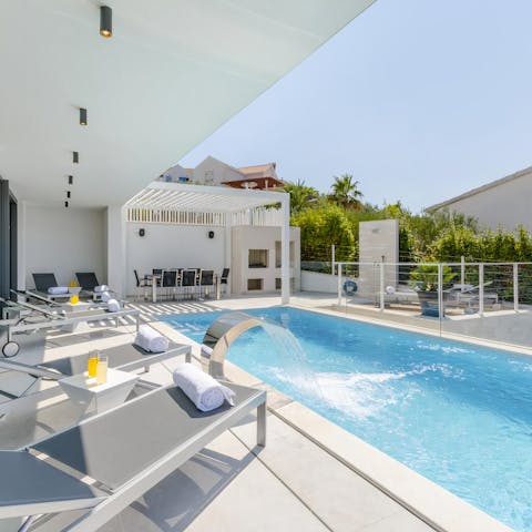 Spend the day swimming in the infinity pool and snoozing on the lounge chairs