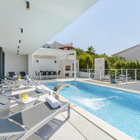 Spend the day swimming in the infinity pool and snoozing on the lounge chairs
