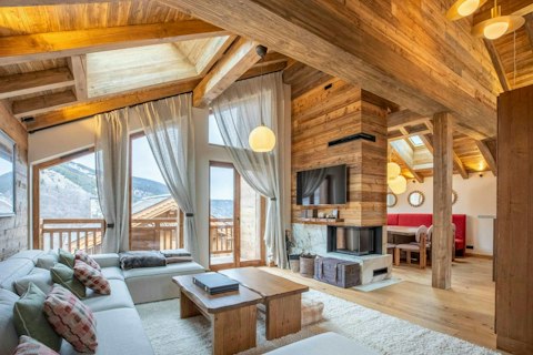 Warm up by the fire with mountain views framing the Alps
