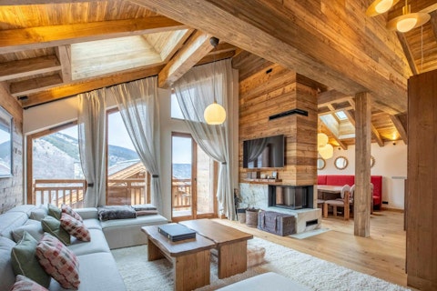 Warm up by the fire with mountain views framing the Alps