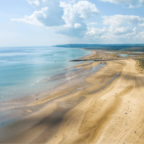 Go for a sandy stroll along Camber Sands beach, fifty yards away